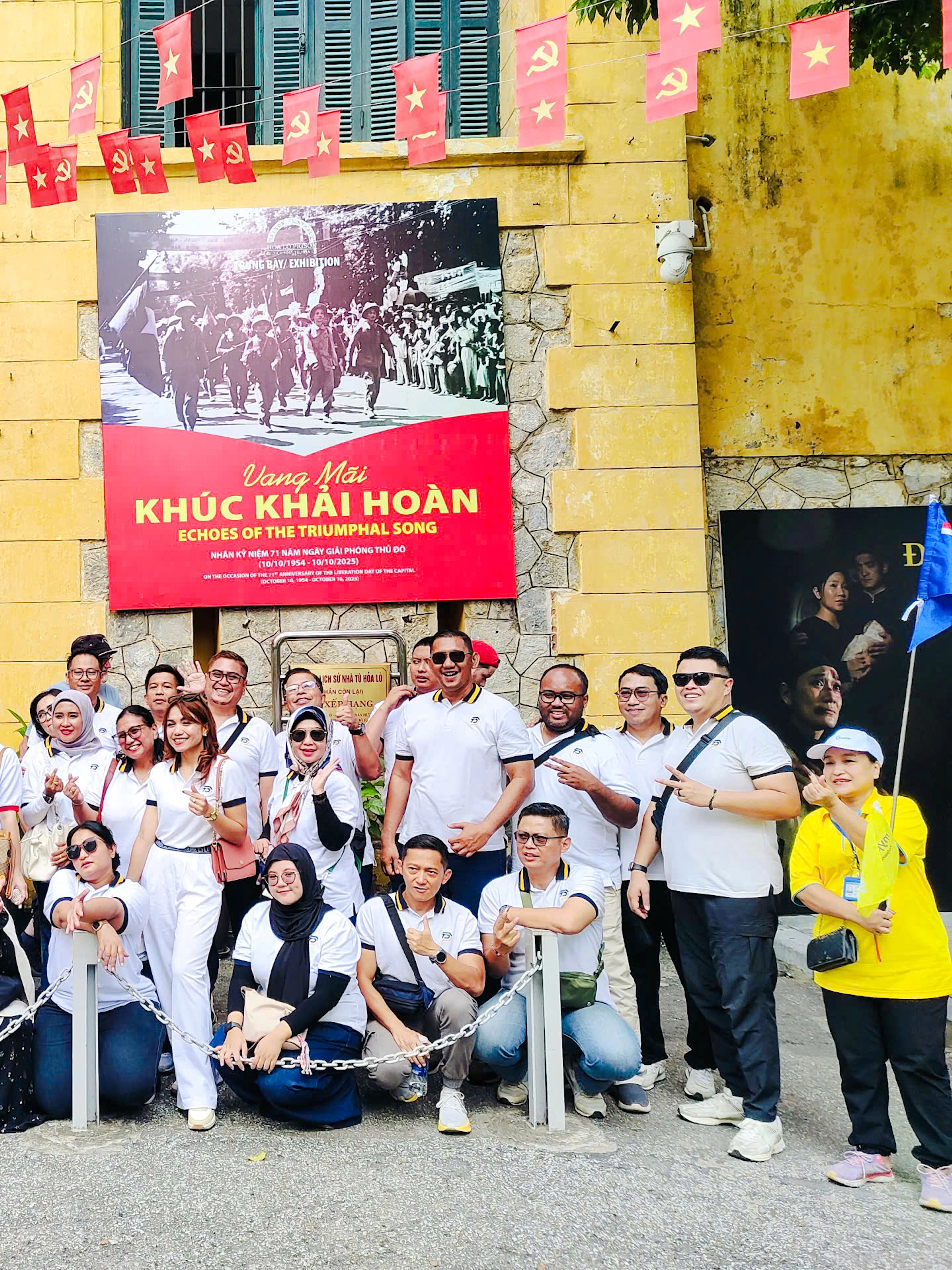 Group of tourists outside Hoa Lo Prison entrance during Hanoi walking tour.