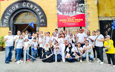 Group of tourists outside Hoa Lo Prison entrance during Hanoi walking tour.