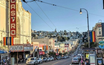 Castro Theatre and rainbow flags on Castro Street, San Francisco, part of self-guided city exploration game.