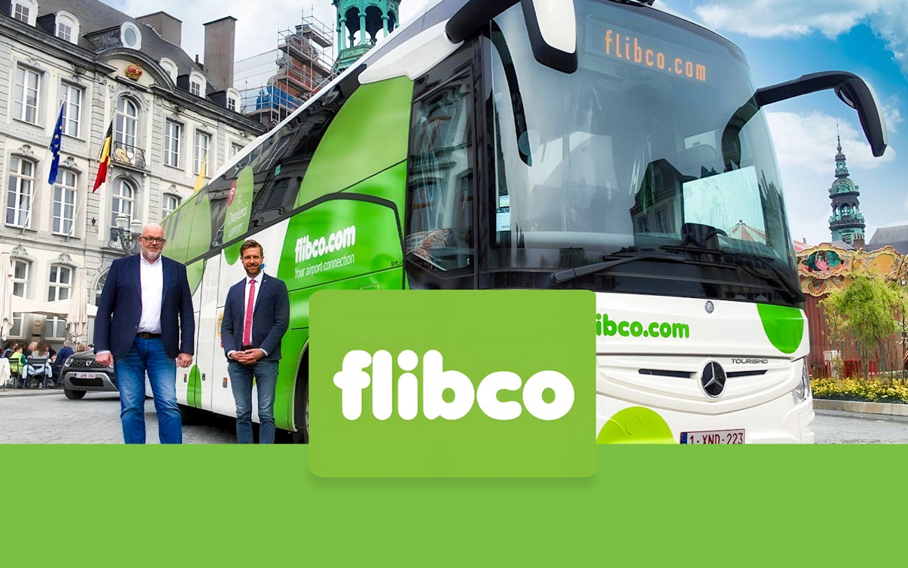 Flibco shuttle bus parked in front of a historic building, offering transport from Frankfurt Hahn Airport to Frankfurt City.