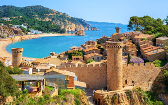 Tossa De Mar coastal view with medieval castle and beach in Spain.