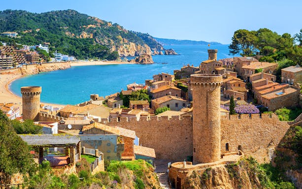 Tossa De Mar coastal view with medieval castle and beach in Spain.