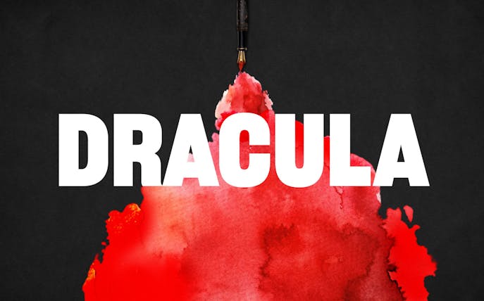 Dracula text with red ink blot on black background