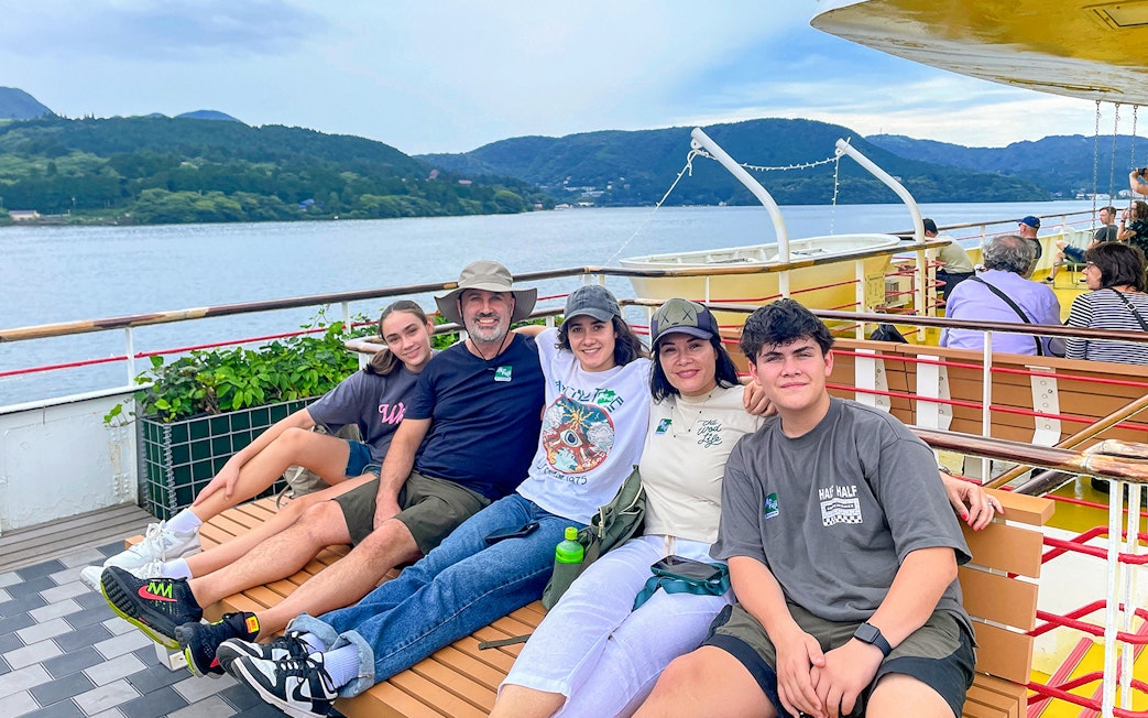 Group enjoying a boat ride on Lake Ashi with Mount Fuji in the background, part of the Fuji & Hakone tour.