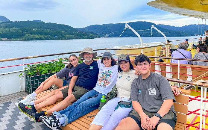Group enjoying a boat ride on Lake Ashi with Mount Fuji in the background, part of the Fuji & Hakone tour.
