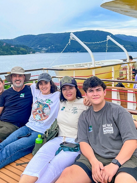Group enjoying a boat ride on Lake Ashi with Mount Fuji in the background, part of the Fuji & Hakone tour.