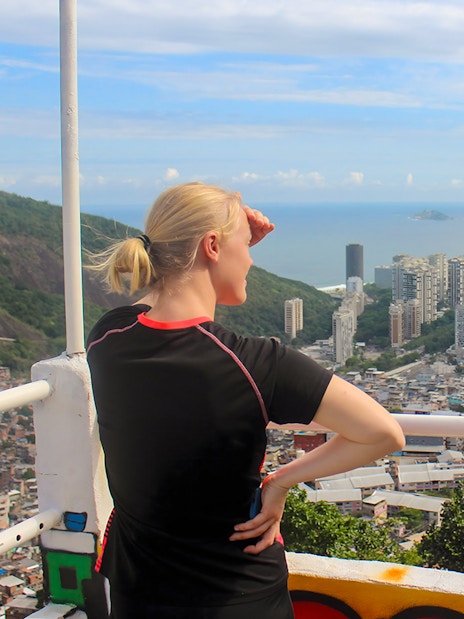 Tourist overlooking Rio de Janeiro from a favela market viewpoint.