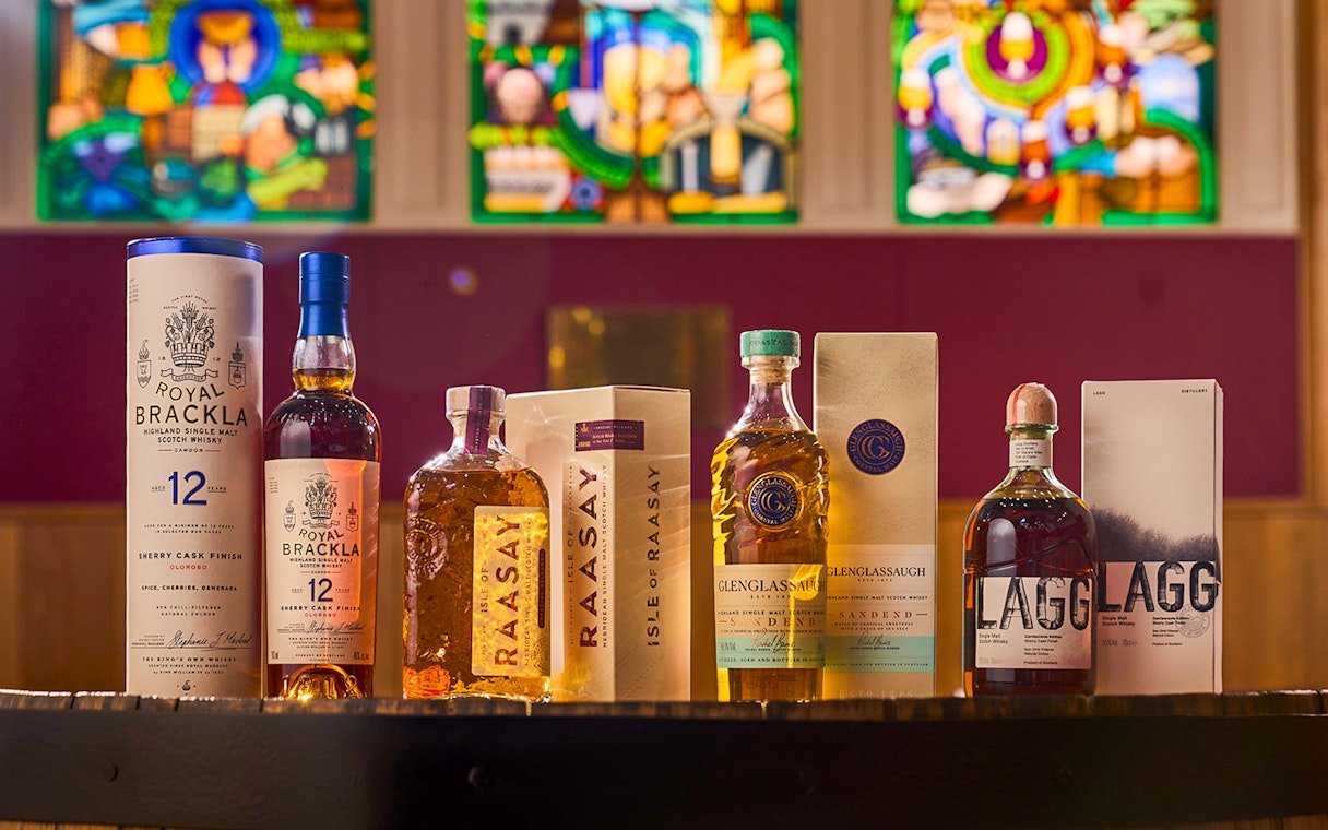 Whisky bottles from Royal Brackla, Isle of Raasay, Glenglassaugh, and Lagg displayed in a tasting catalog.