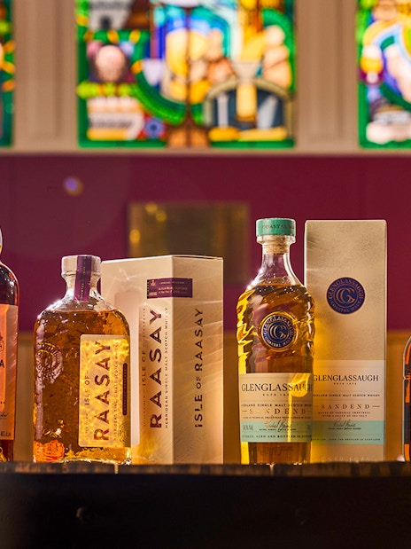 Whisky bottles from Royal Brackla, Isle of Raasay, Glenglassaugh, and Lagg displayed in a tasting catalog.
