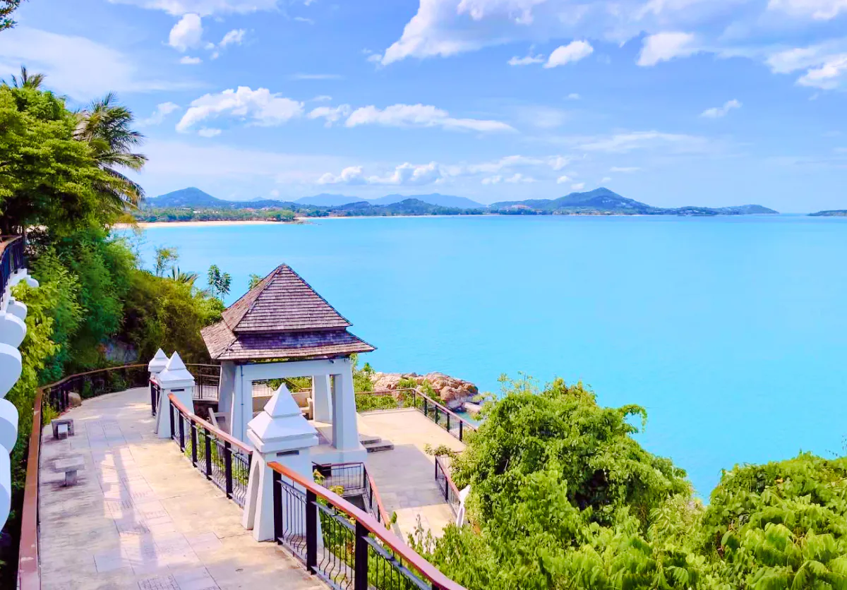 Scenic view of Koh Samui coastline with a pavilion and lush greenery.