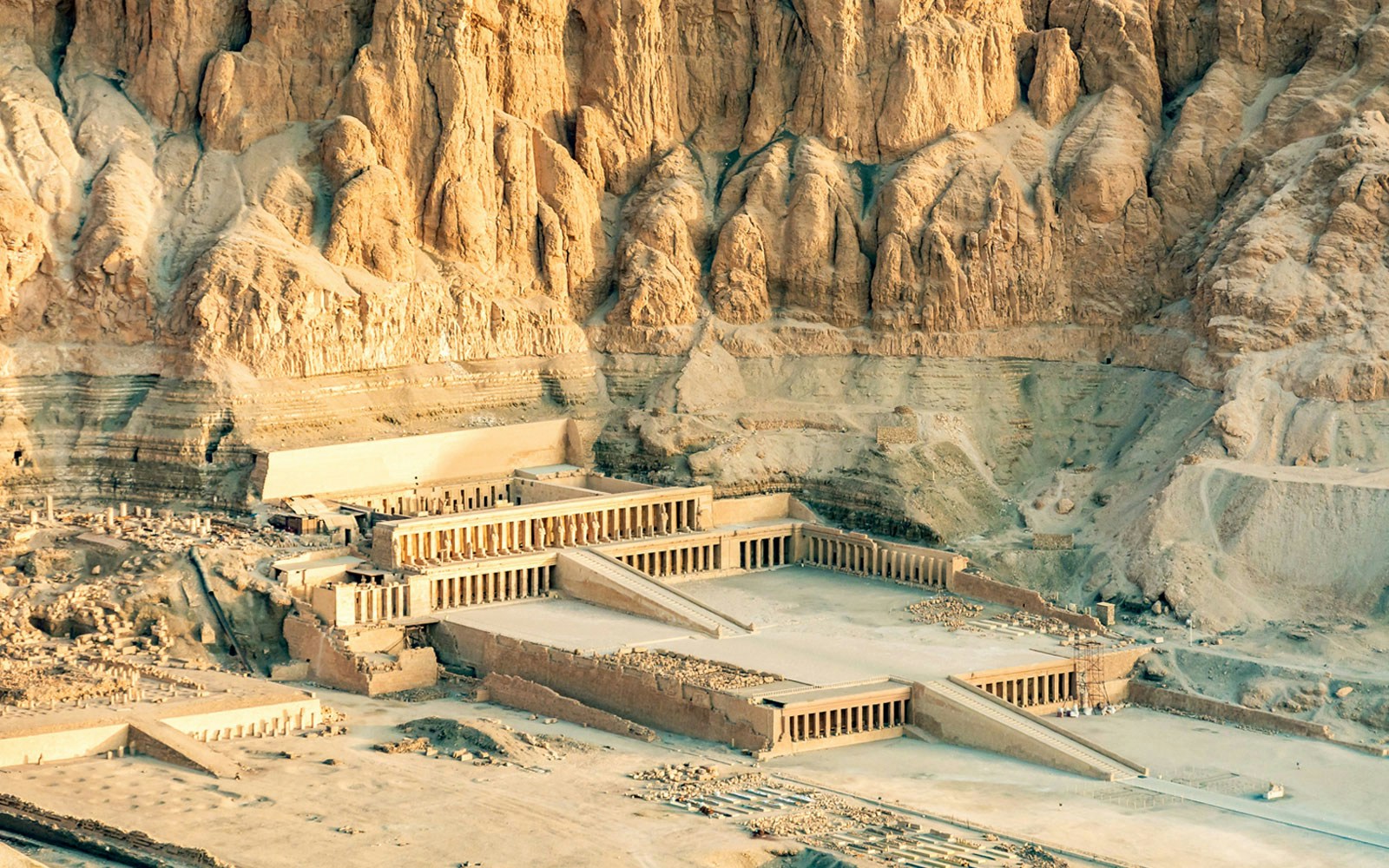 Valley of the Kings Luxor, ancient temple complex, rocky cliffs in background.