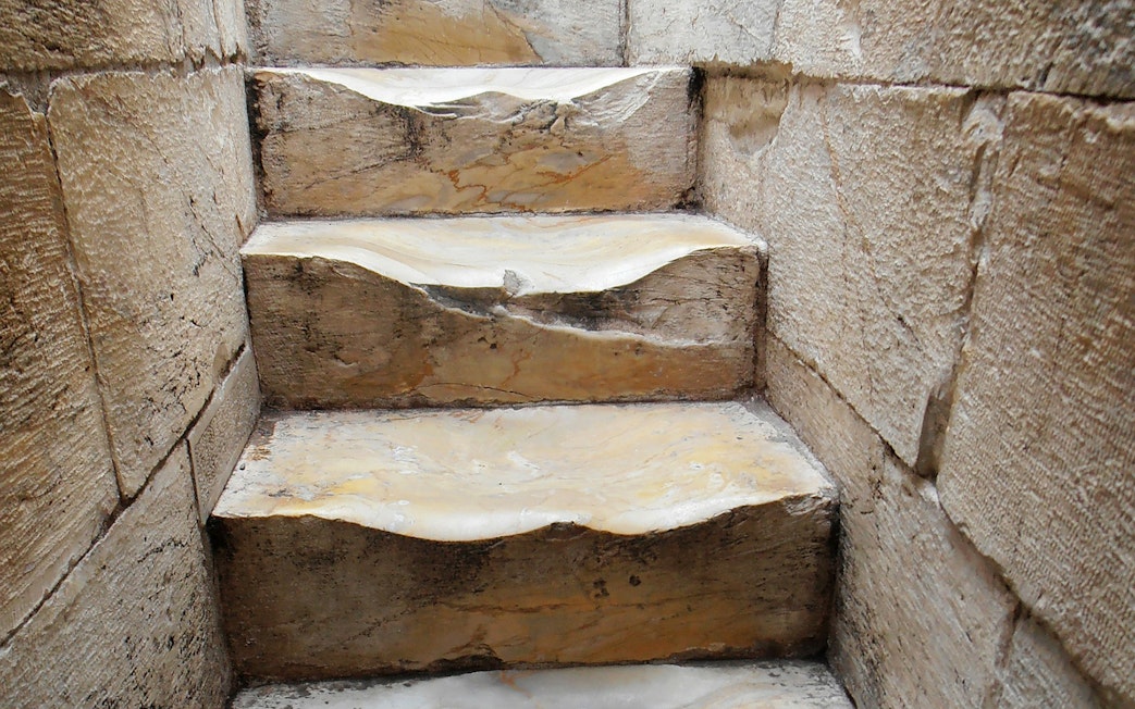 Worn stone steps inside the Leaning Tower of Pisa, Italy.