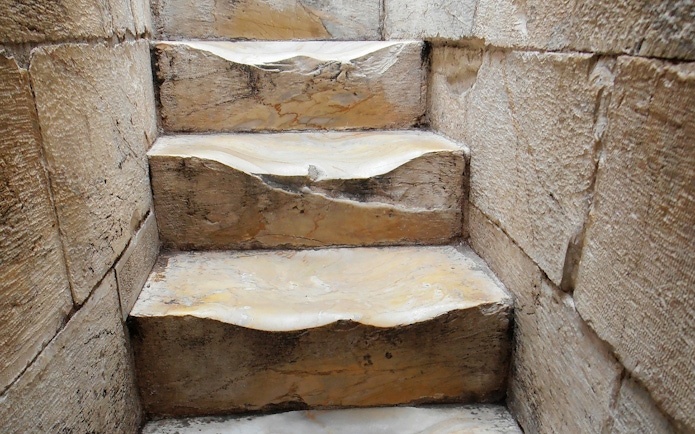 Worn stone steps inside the Leaning Tower of Pisa, Italy.