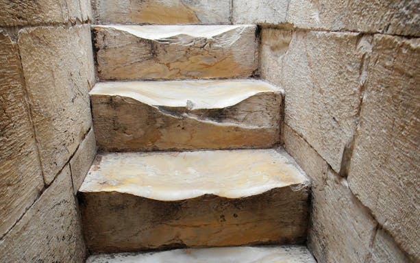 Worn stone steps inside the Leaning Tower of Pisa, Italy.
