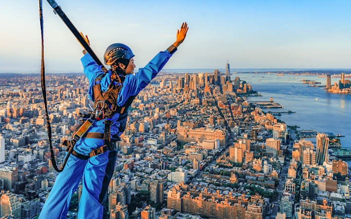 Person in harness enjoying view from skyscraper in New York City with Edge Express Pass.