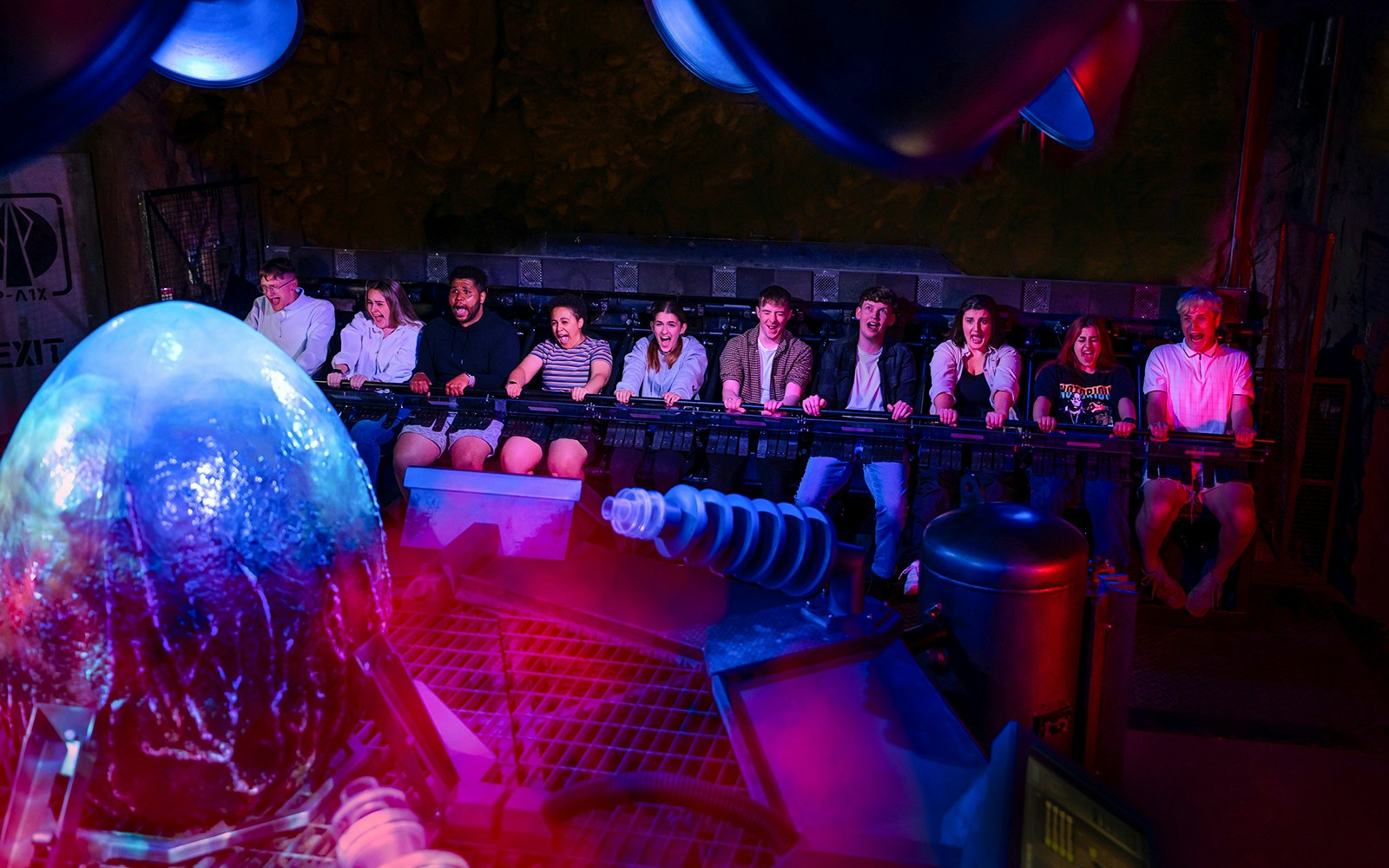 Visitors experiencing Nemesis Sub-Terra ride at Alton Towers with glowing alien egg.