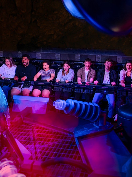 Visitors experiencing Nemesis Sub-Terra ride at Alton Towers with glowing alien egg.