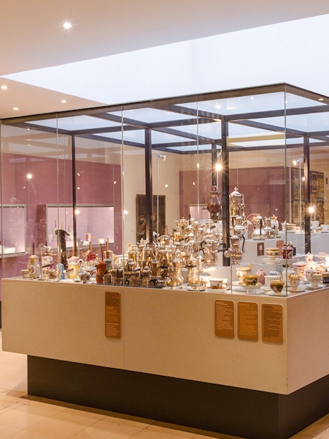 Woman observing chocolate artefacts display at Chocolate Museum Paris.