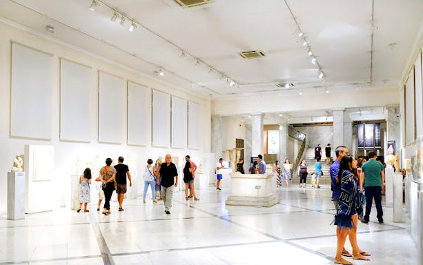 Visitors exploring exhibits at Athens National Archaeological Museum.