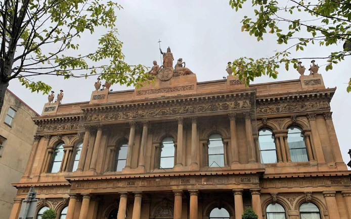 Belfast city hall facade with ornate sculptures, part of Ghosts of Belfast tour.