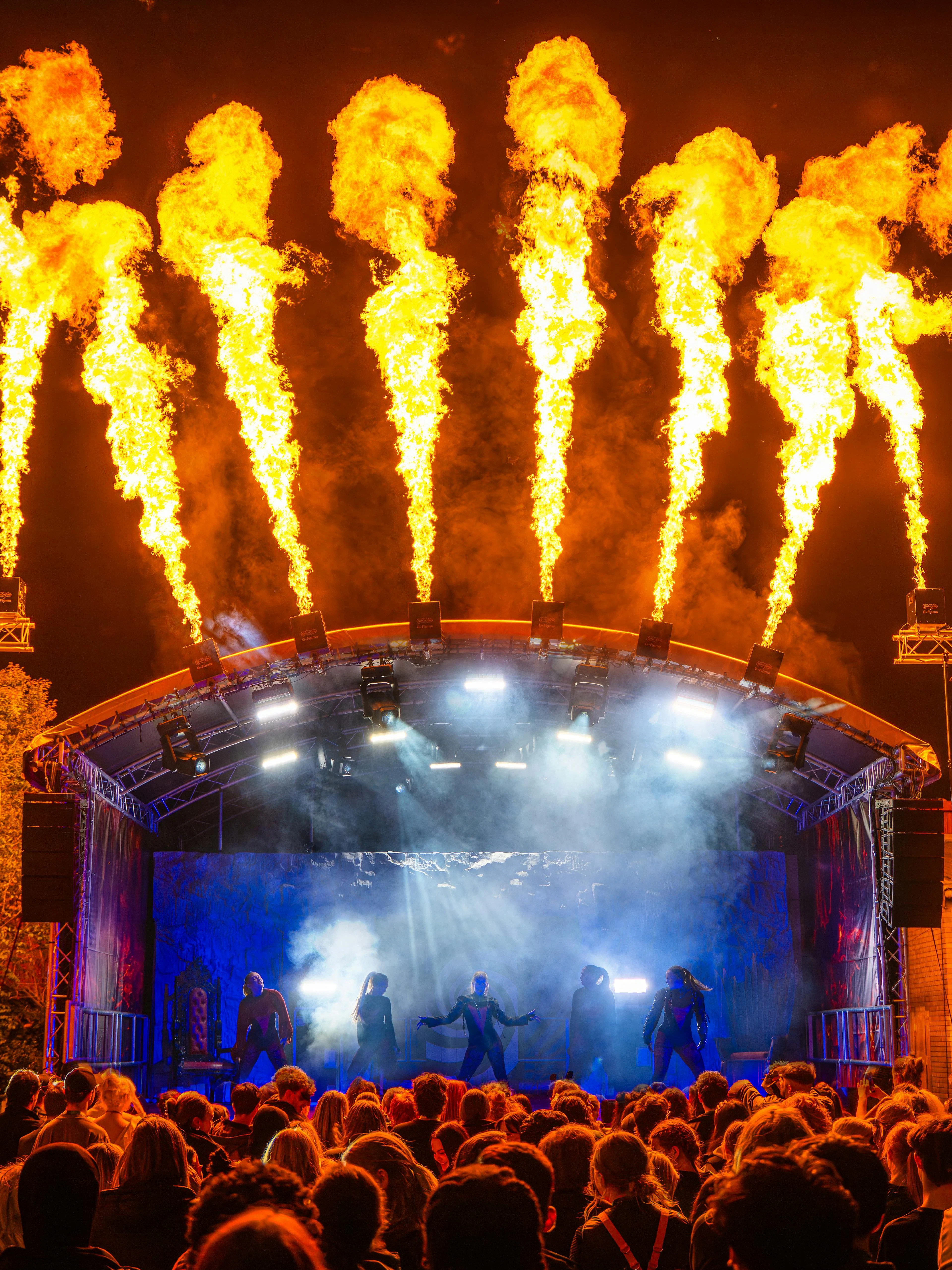 Crowd watching a fiery stage performance at Thorpe Park Fright Nights.