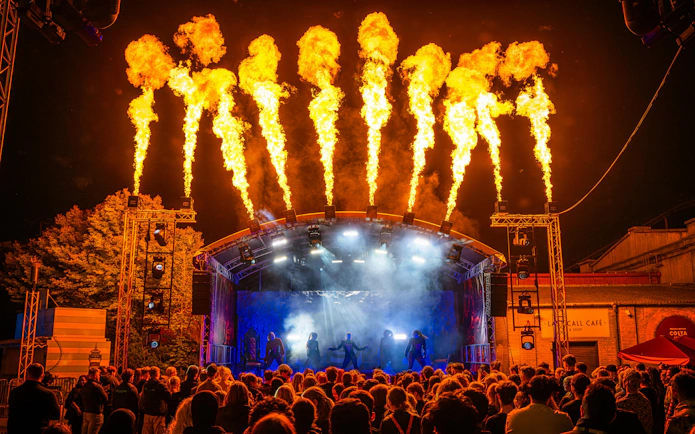 Crowd watching a fiery stage performance at Thorpe Park Fright Nights.