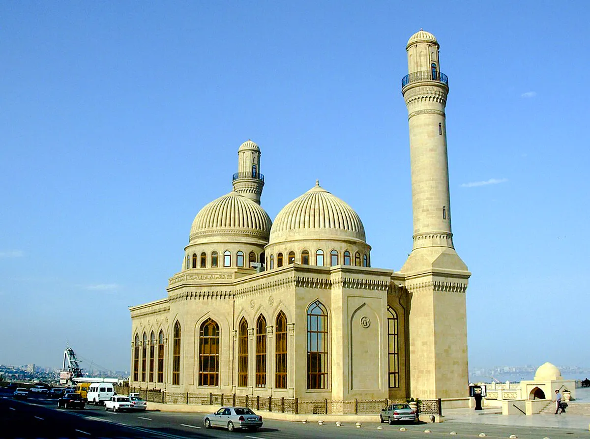 Mosque with domes and minaret in Baku, seen on the Half Day Tour to Gobustan National Park.