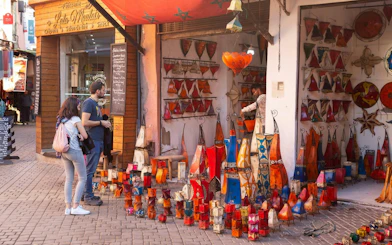 Souvenir shop with colorful lanterns in Fes Old Medina market.