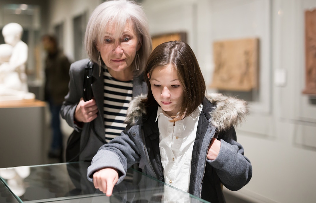 Grandmother and granddaughter exploring an zoo museum exhibit.