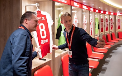 Visitors taking a selfie in the Johan Cruijff ArenA locker room during the Classic Tour.