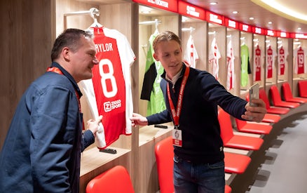 Visitors taking a selfie in the Johan Cruijff ArenA locker room during the Classic Tour.