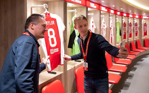Visitors taking a selfie in the Johan Cruijff ArenA locker room during the Classic Tour.