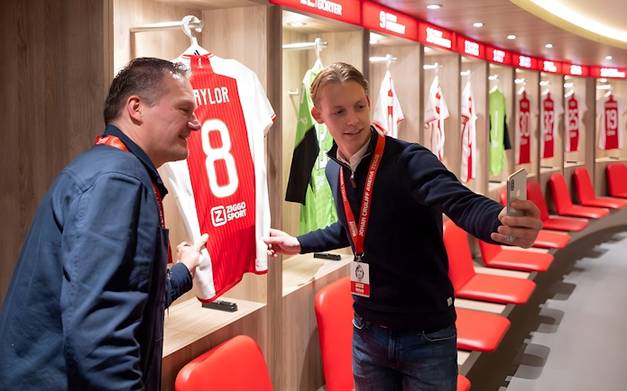 Visitors taking a selfie in the Johan Cruijff ArenA locker room during the Classic Tour.