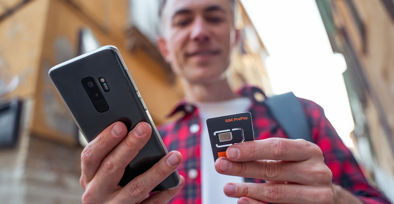 man placing local sim card