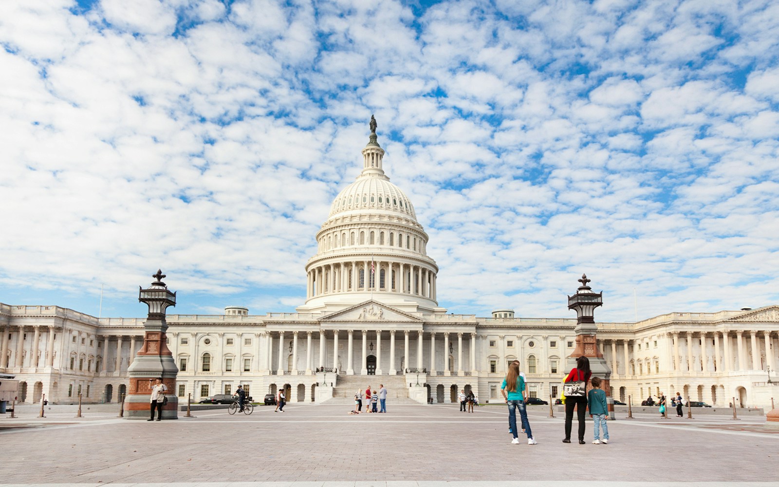 Capitol building in Washington DC with visitors in the foreground.