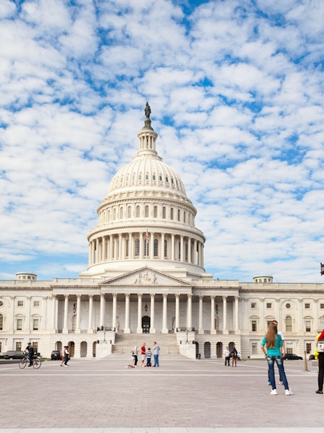 Capitol building in Washington DC with visitors in the foreground.