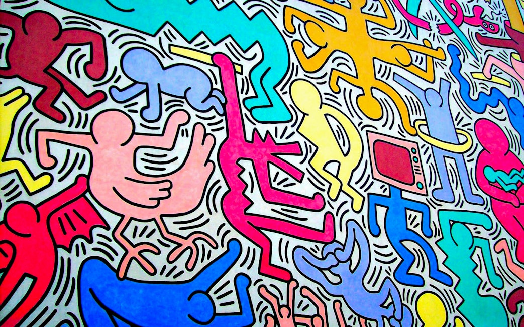 Colorful mural art with abstract human figures, Pisa walking tour.