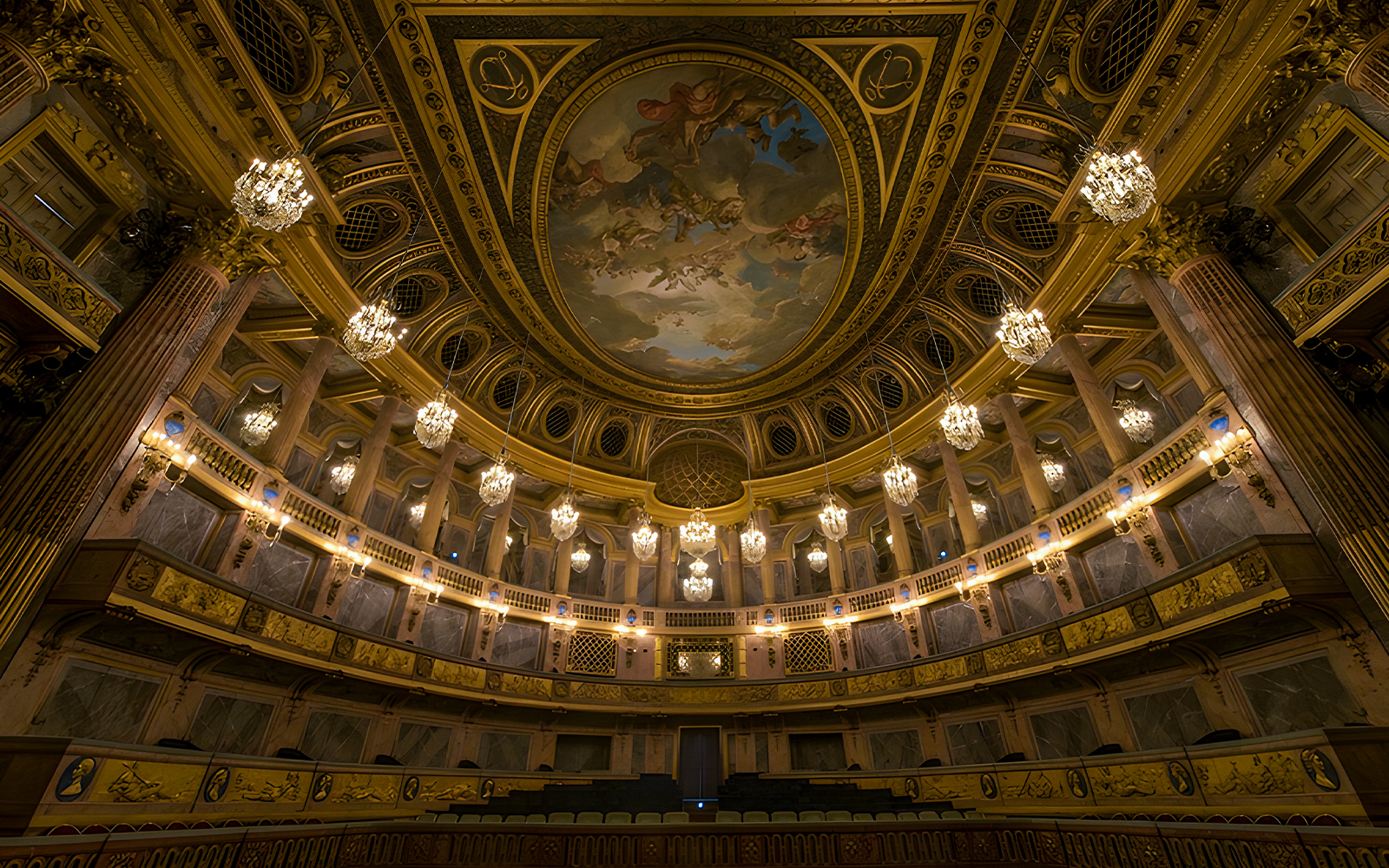 Royal Opera Versailles interior with ornate decorations and grand chandeliers.