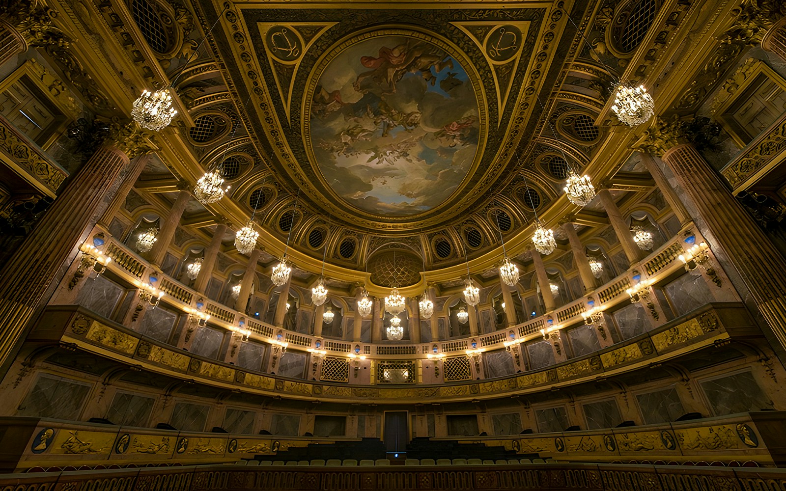 Royal Opera Versailles interior with ornate decorations and grand chandeliers.