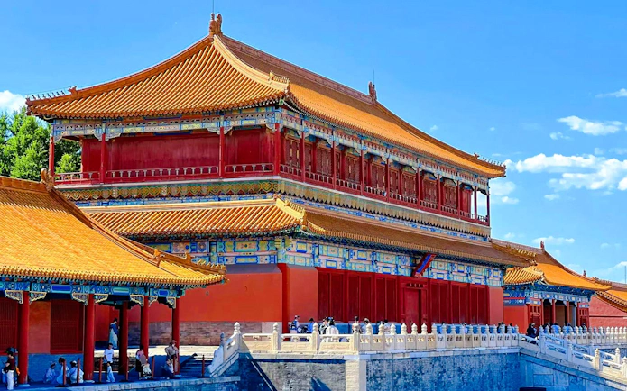 Traditional building in the Forbidden City, Beijing, China, with ornate roof and vibrant colors.