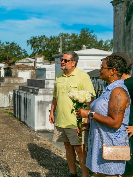 Tour guide explaining tombs to guests in St. Louis Cemetery, New Orleans.