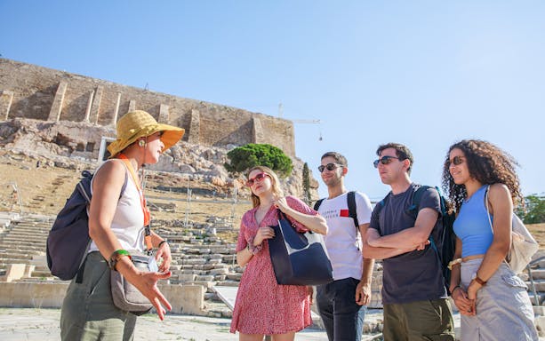 Tour guide explaining citadel ruins to group in Athens.