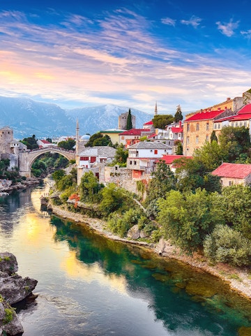 Mostar's Old Bridge over Neretva River with historic buildings, view from Dubrovnik tour.