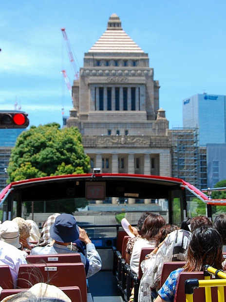 Open-top bus tour in Tokyo passing the National Diet Building.