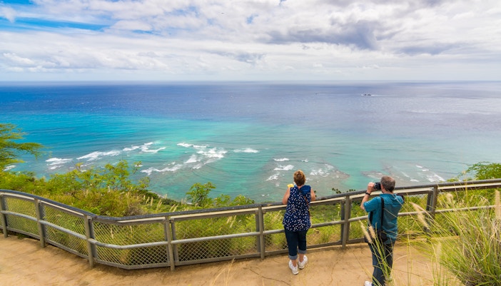 Visitors enjoying panoramic ocean view from Diamond Head State Monument, Oahu, Hawaii.