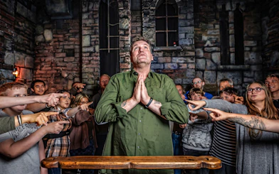 Visitors participate in an interactive experience at Hamburg Dungeon.