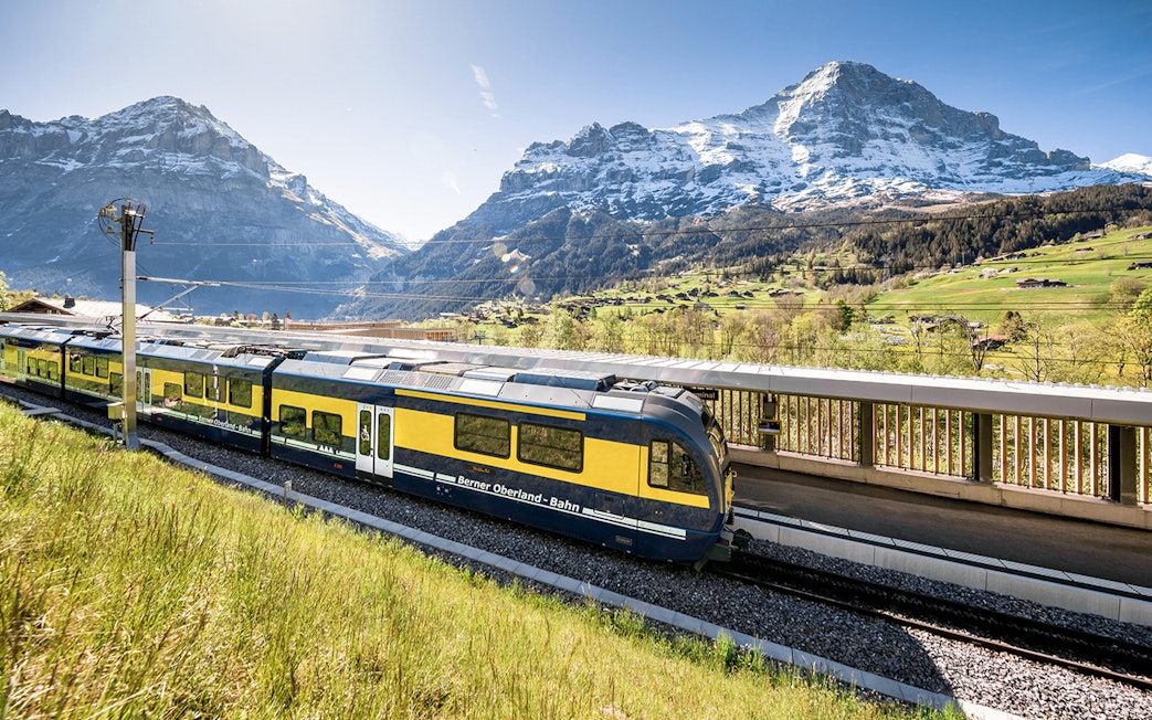 Train at station with Swiss Alps view, Bernese Oberland route to Jungfraujoch.