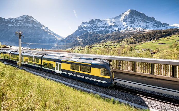 Train at station with Swiss Alps view, Bernese Oberland route to Jungfraujoch.