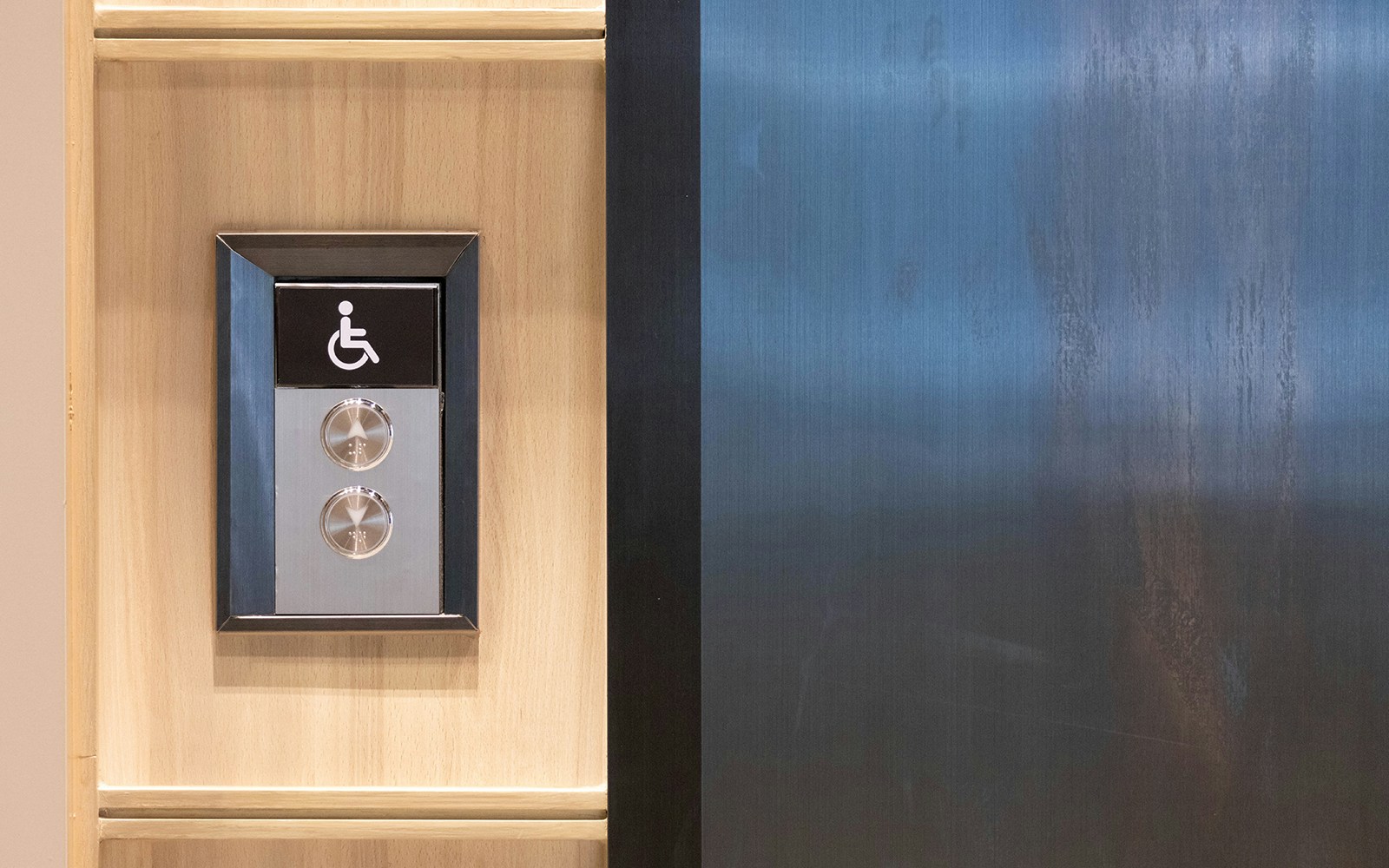 Elevator control panel with wheelchair symbol inside church.