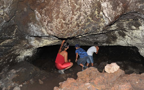 Exploring a lava cave on a guided trek to the south side of Mount Etna.